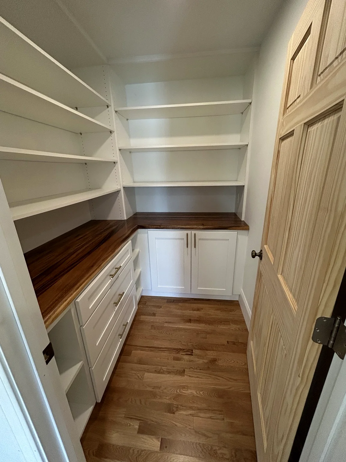 Custom pantry with shelving and wood countertops